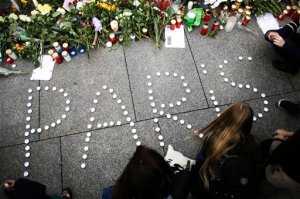 Young women have formed  the word Paris with candles to mourn for the victims killed in  Friday's attacks in Paris, France, in front of the French Embassy in Berlin, Saturday, Nov. 14, 2015. French President Francois Hollande said more than 120 people died Friday night in shootings at Paris cafes, suicide bombings near France's national stadium and a hostage-taking slaughter inside a concert hall.  (AP Photo/Markus Schreiber)