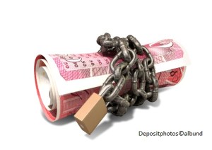 A rolled up british one hundred pound note wrapped with chains and secured with a padlock on an isolated background