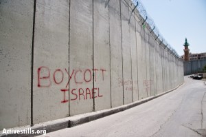 EAST JERUSALEM, OCCUPIED PALESTINIAN TERRITORIES - MARCH 26: Graffiti on the Israeli separation barrier dividing the East Jerusalem neighborhood of Abu Dis reads, "Boycott Israel".