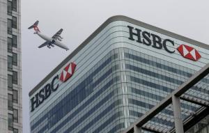 A Swiss International aircraft flies past the HSBC headquarters building in the Canary Wharf financial district in east London in this February 15, 2015 photo. REUTERS/Peter Nicholls/Files